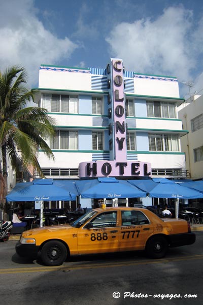 taxi jaune passe devant hôtel Colony de Miami beach