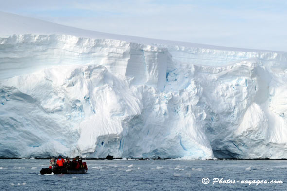 Zodiac approching a massive glacier in Antarctica