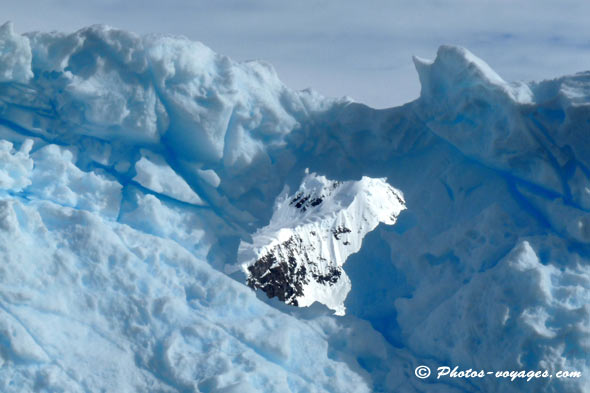 Antarctica landscape through the hole of an iceberg