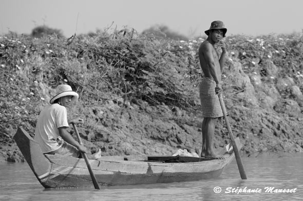 Cambodian fishermen on a small wooden boat