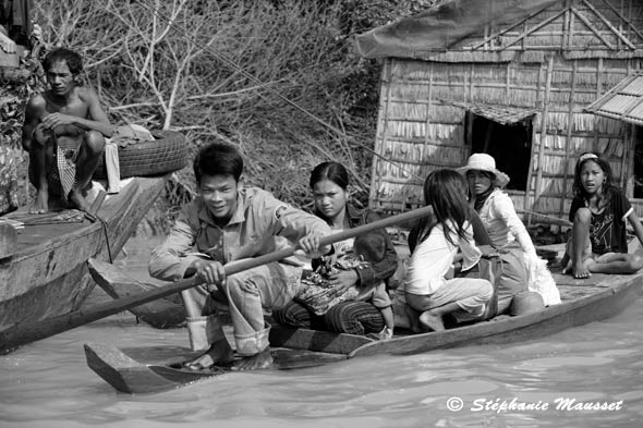 Cambodian family on a small wooden boat