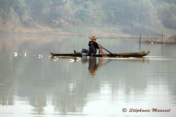 Cambodian Fisherman on a pirogue