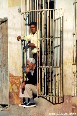 two cuban men drinking coffee