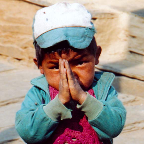 child forming the Namaste sign