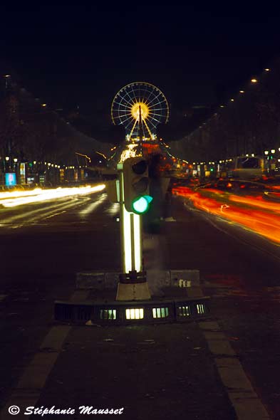 Night shot of champs Elysees with millenium wheel