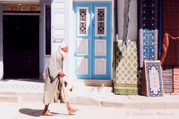 old tunisian with his cane in the street