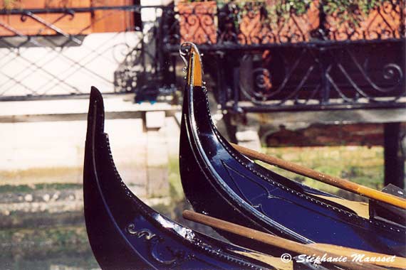 Close up on prow of black gondolas