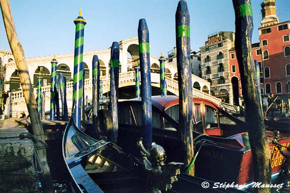 Gondola docked at rialto bridge in Venice